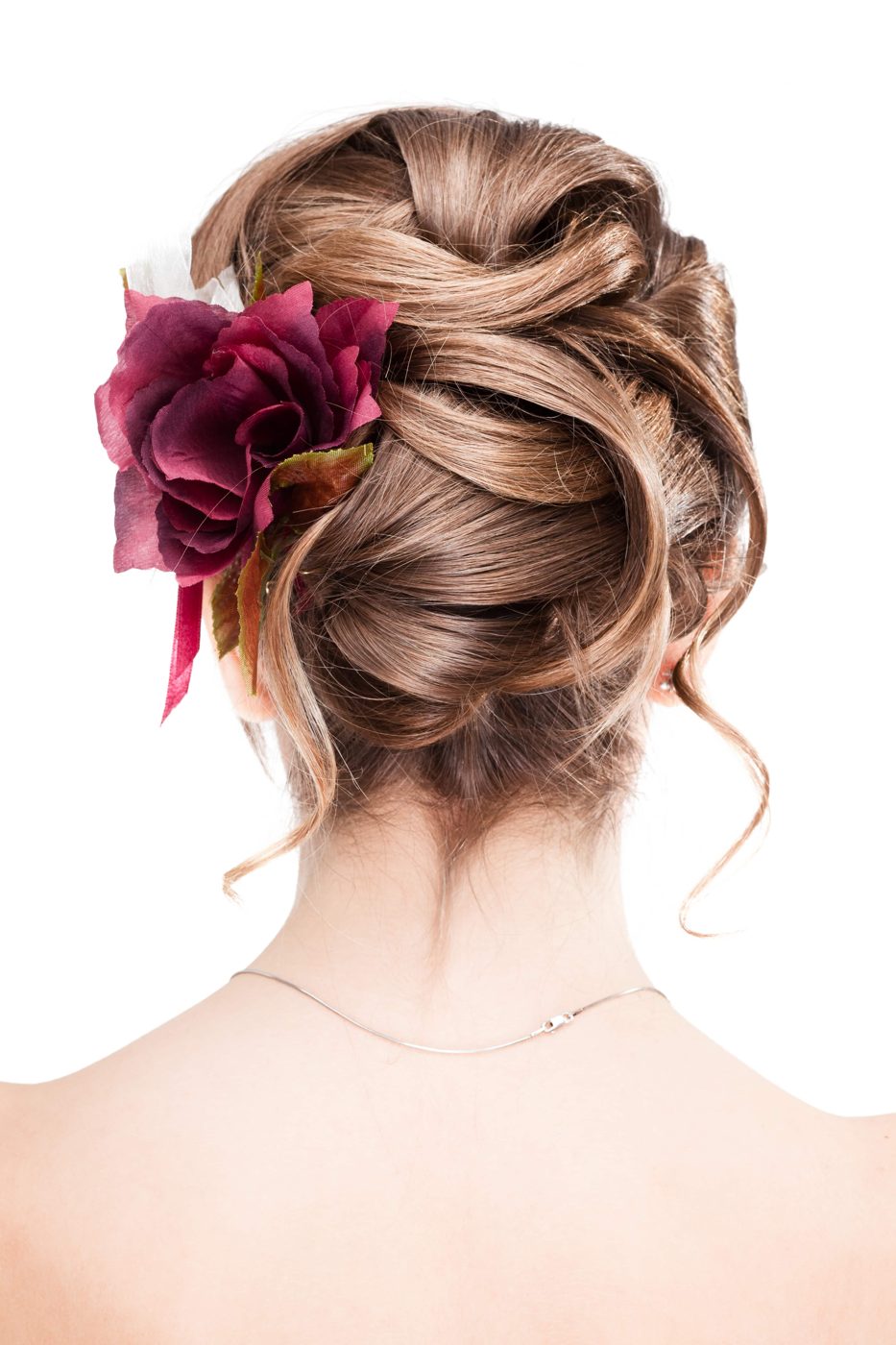 Braided updo finished with a flower accent